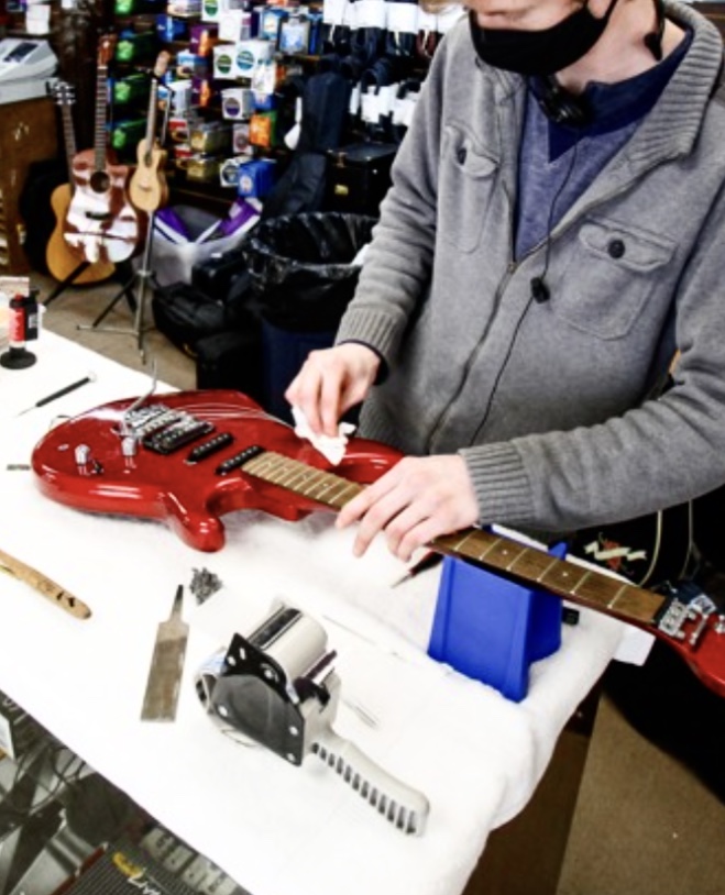 Guitar being restrung and cleaned